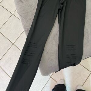 Large silky healing leggings with cuts through them that open up when you put on